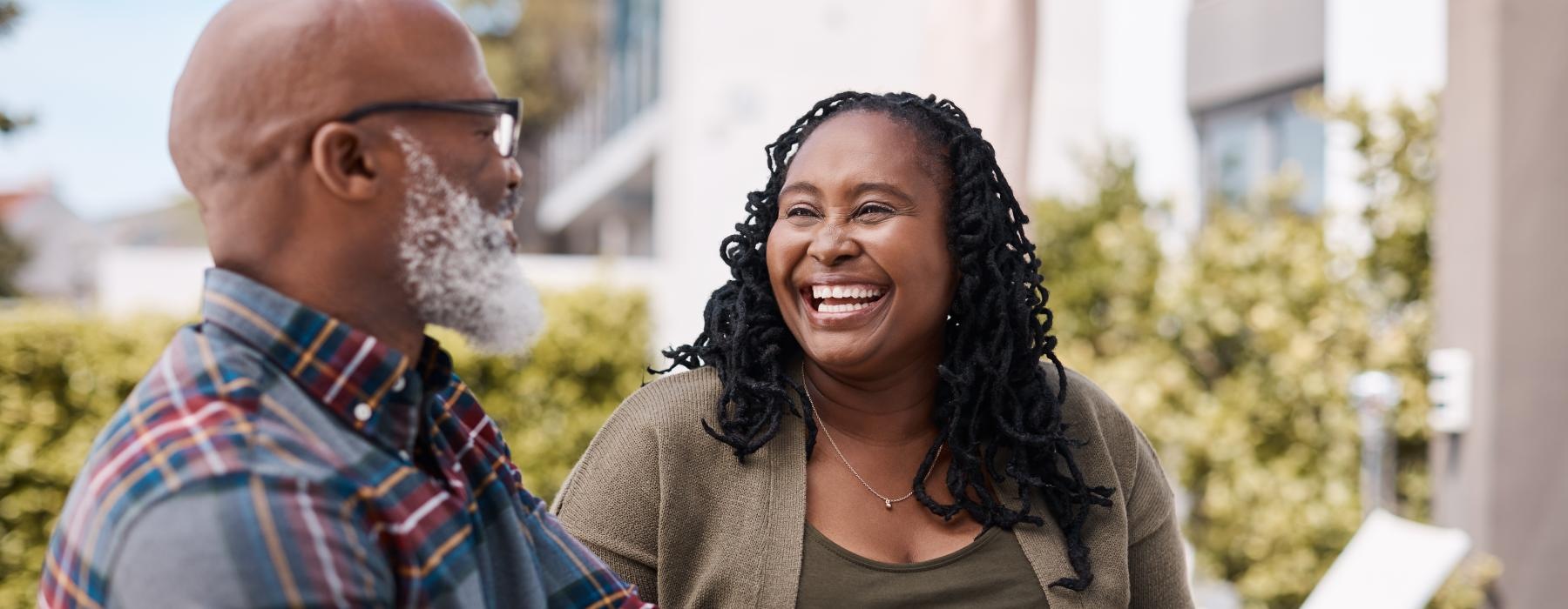 Couple sitting outside laughing 