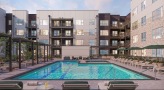 swimming pool in a courtyard with lounge chairs