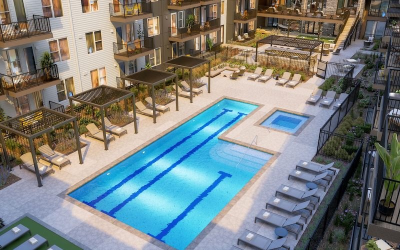 aerial view of a courtyard with a pool and lounge chairs