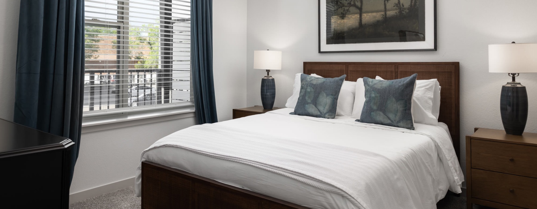 a bedroom with a bed and two nightstands
