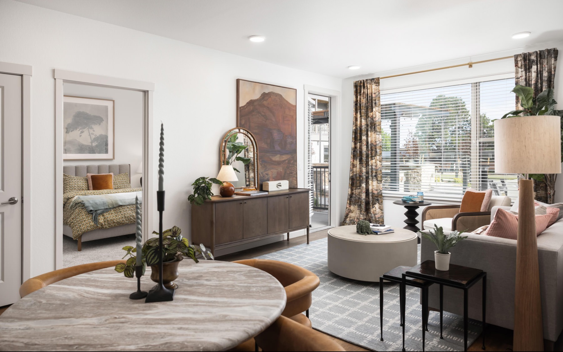 a living room with a couch, tv and chairs