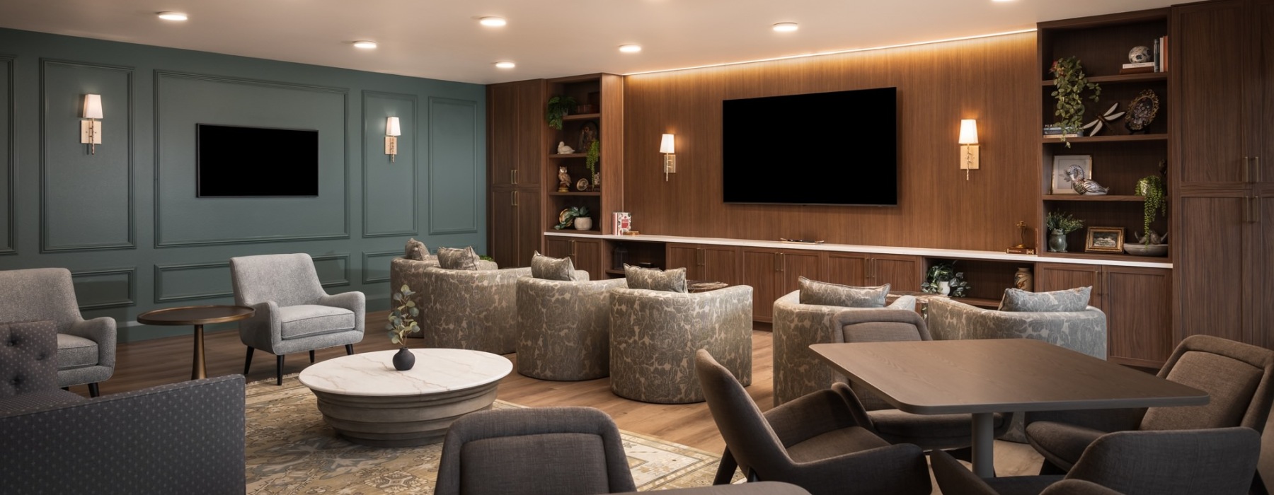a spacious movie lounge with seating and tables