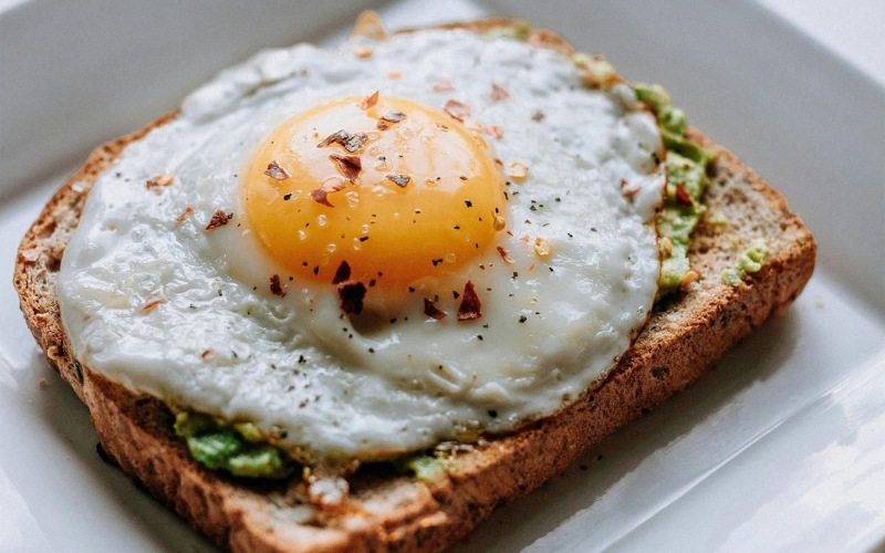 Bustling community with plenty of dining choices a breakfast sandwich with an egg on top