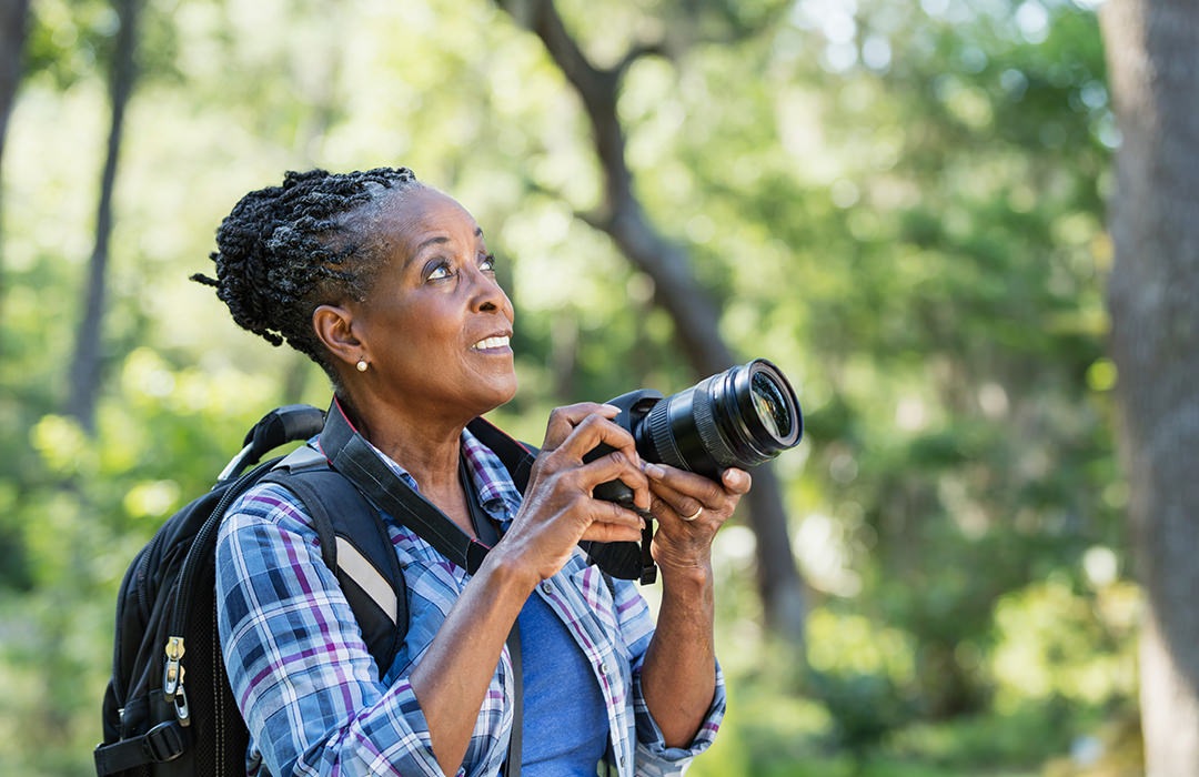 Woman walking in nature taking photos