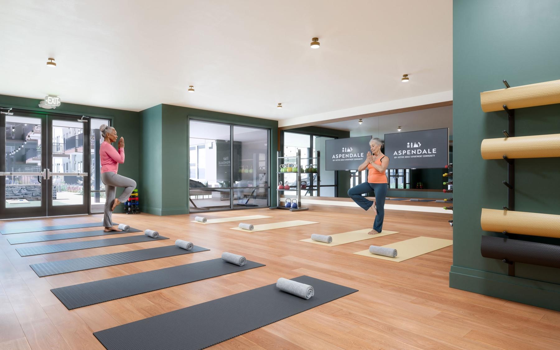 a couple of women exercising in a gym