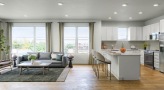 a large kitchen with a couch and a table